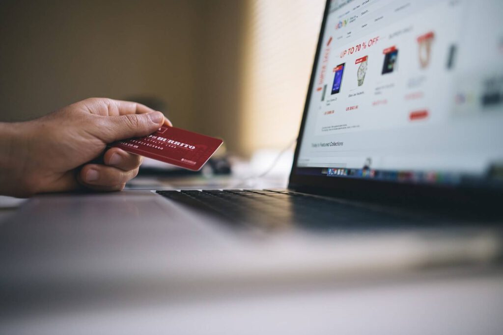 Person holding a credit card to shop online