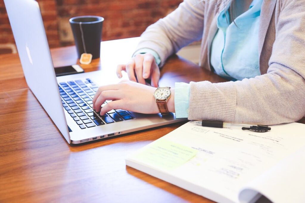 Student typing on a Laptop